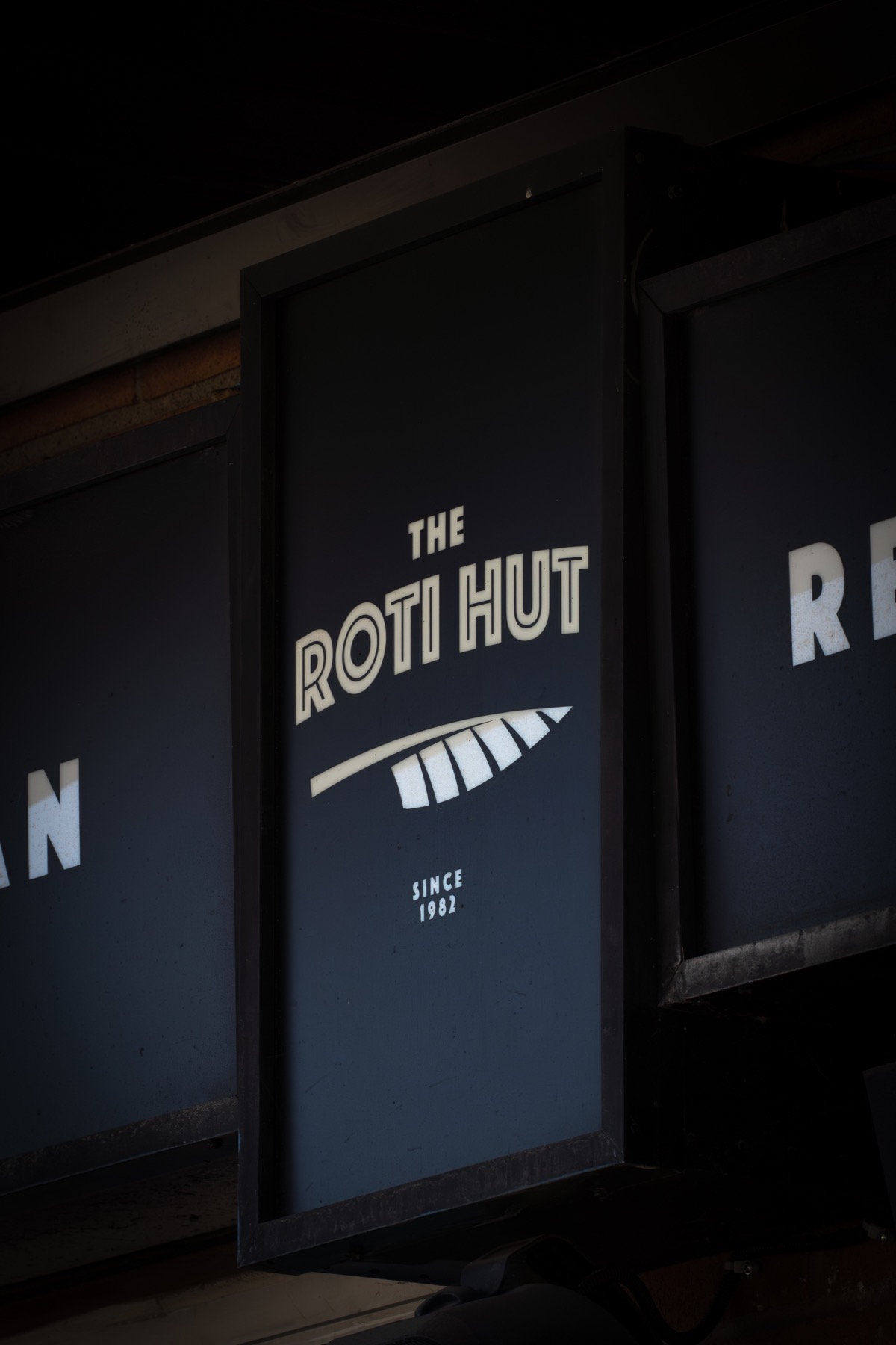 The Roti Hut storefront sign